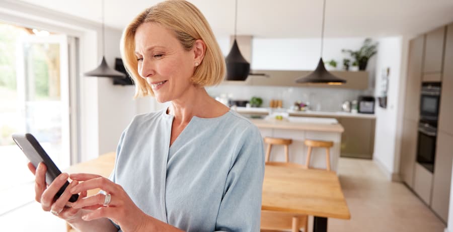 Woman with mobile device in a stylish home